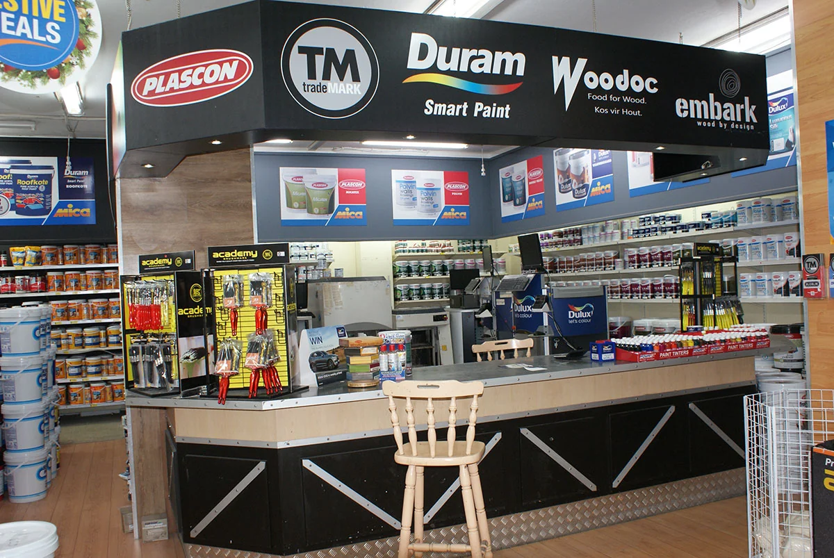 In-store paint counter with tinting equipment and paint ranges on display