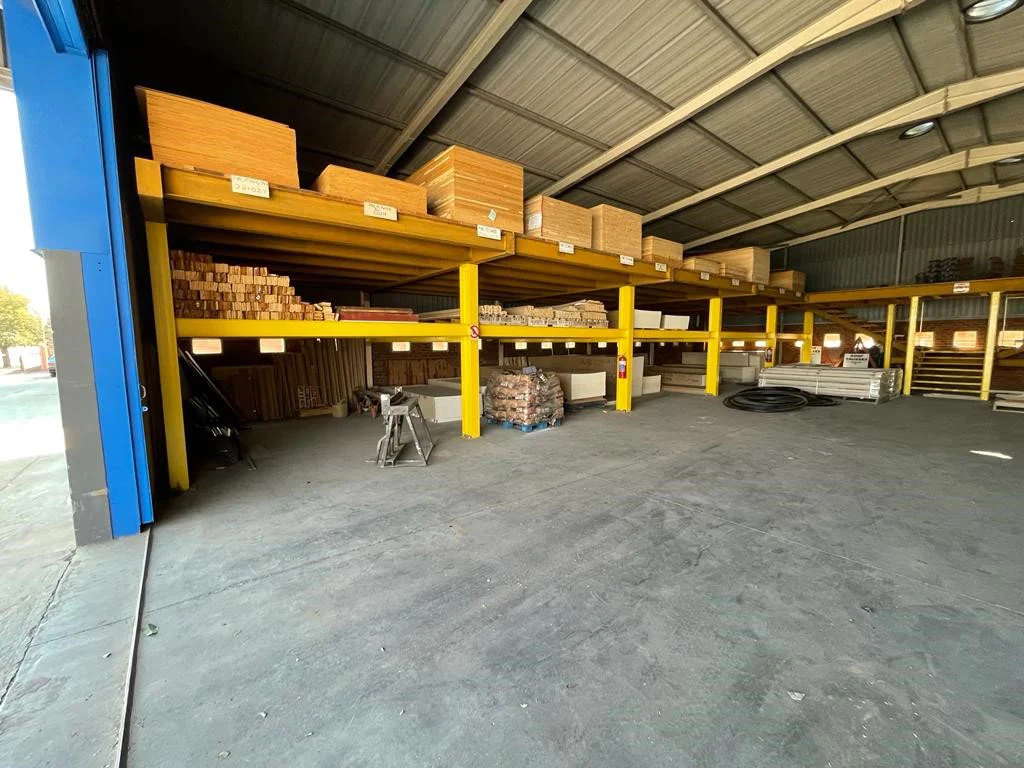 Covered warehouse bay with racked boards and sheet material